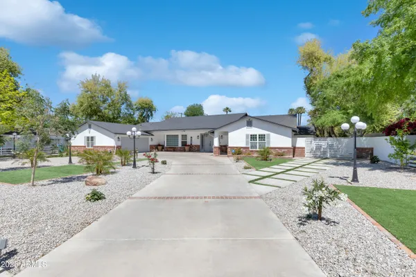 a view of house with a yard and sitting area