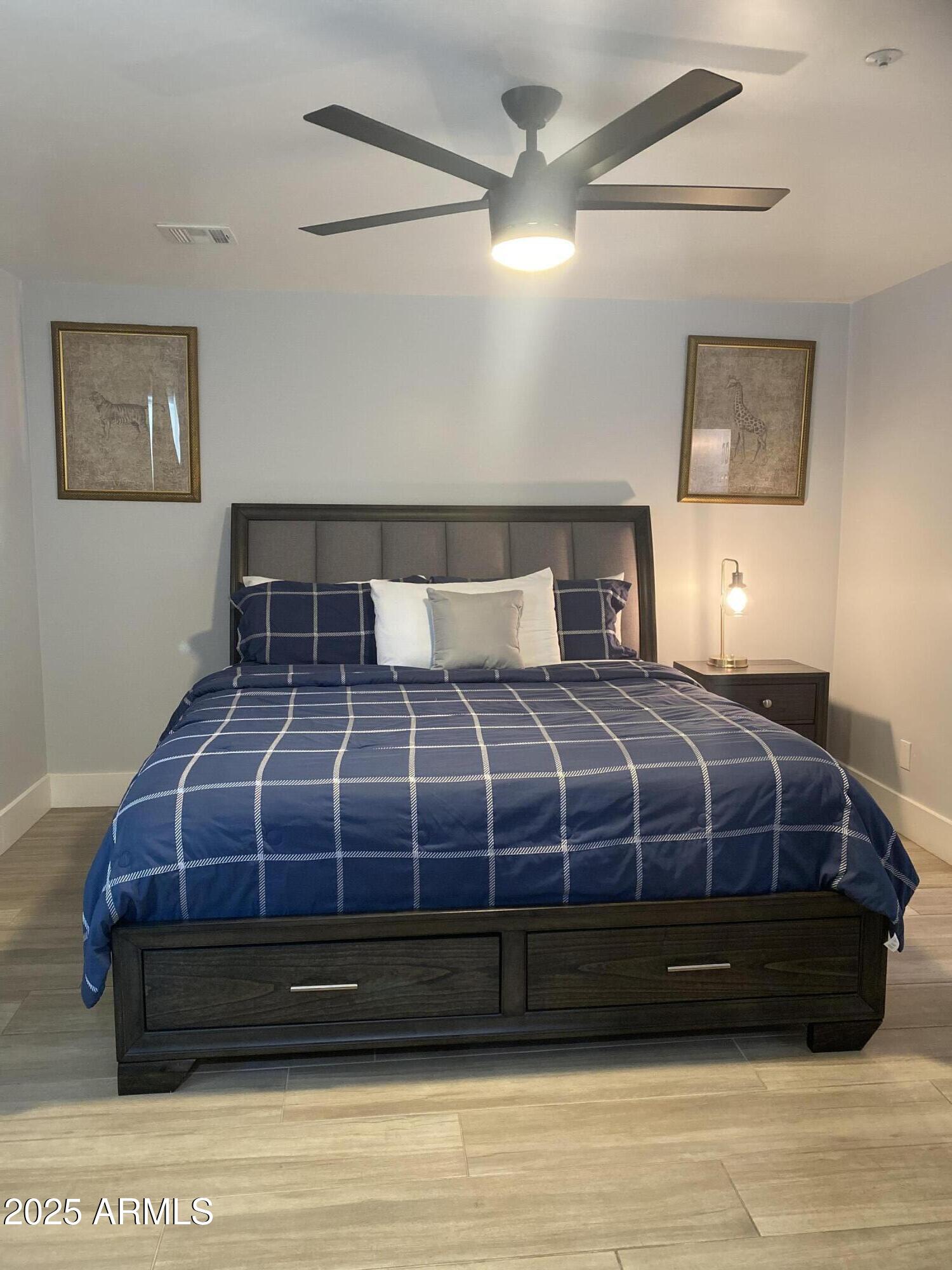 516 West Rancho Drive Phoenix, AZ 85013 - Photo 31 of 46 a bedroom with a bed a painting on the wall and a chandelier