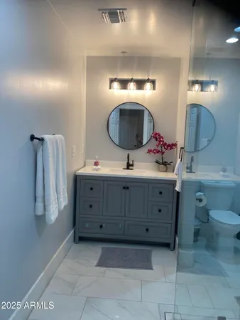 a bathroom with a double vanity sink and a mirror