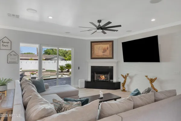 a living room with furniture a fireplace and a flat screen tv