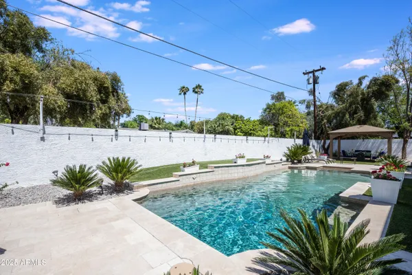 a swimming pool with outdoor seating and yard