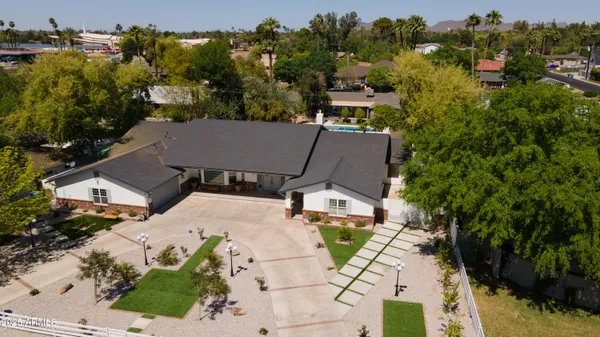 an aerial view of a house with a yard