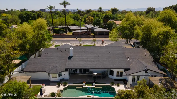 an aerial view of a house with garden space and street view