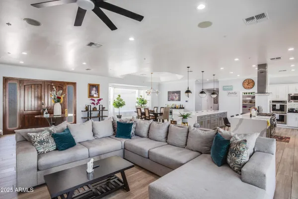 a living room with furniture and kitchen view