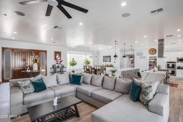 a living room with furniture and kitchen view