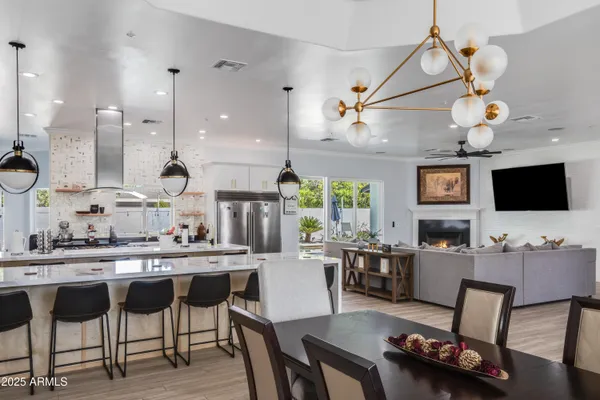 a kitchen with a dining table chairs and view living room