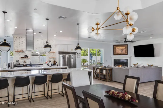 a kitchen with a dining table chairs and view living room