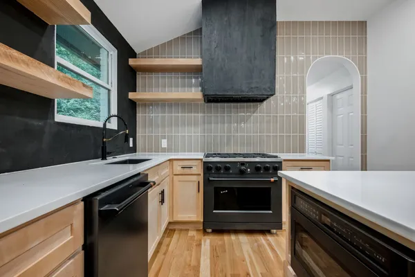 a kitchen with a sink stove and cabinets