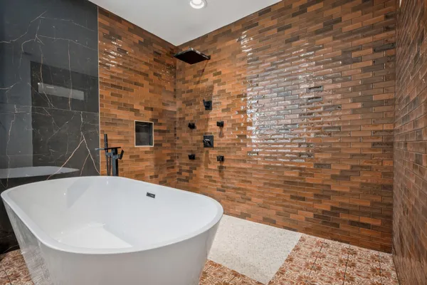 a bathroom with a bathtub and shower