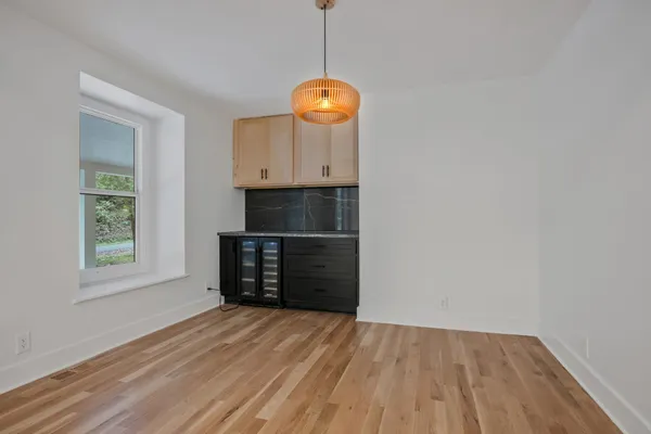 a view of room with window and wooden floor