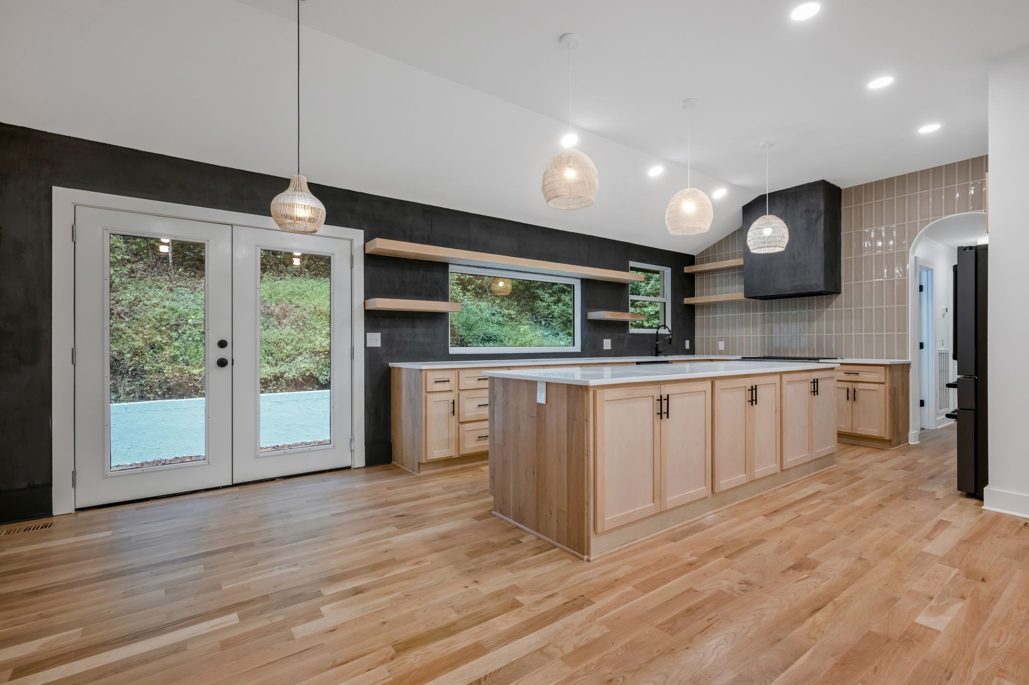 1032 Paint Pony Trail Pegram, TN 37143 - Photo 8 of 30 a large kitchen with stainless steel appliances a large counter top a sink a refrigerator a center island a stove and a window