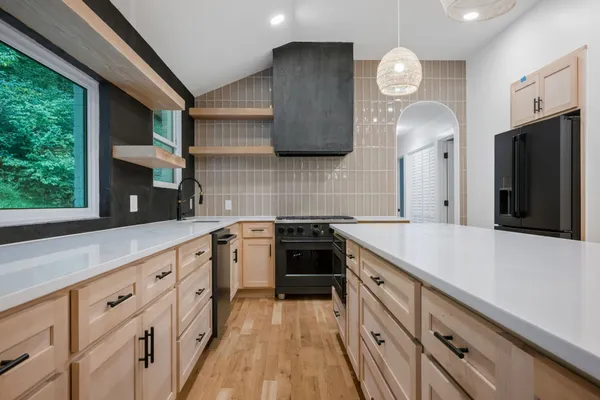 a kitchen with cabinets and stainless steel appliances