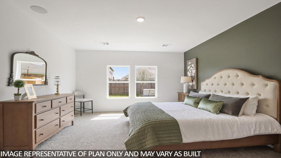 1711 Portia Lane Conroe, TX 77301 - Photo 11 of 26 a bedroom with a bed and window with lamp