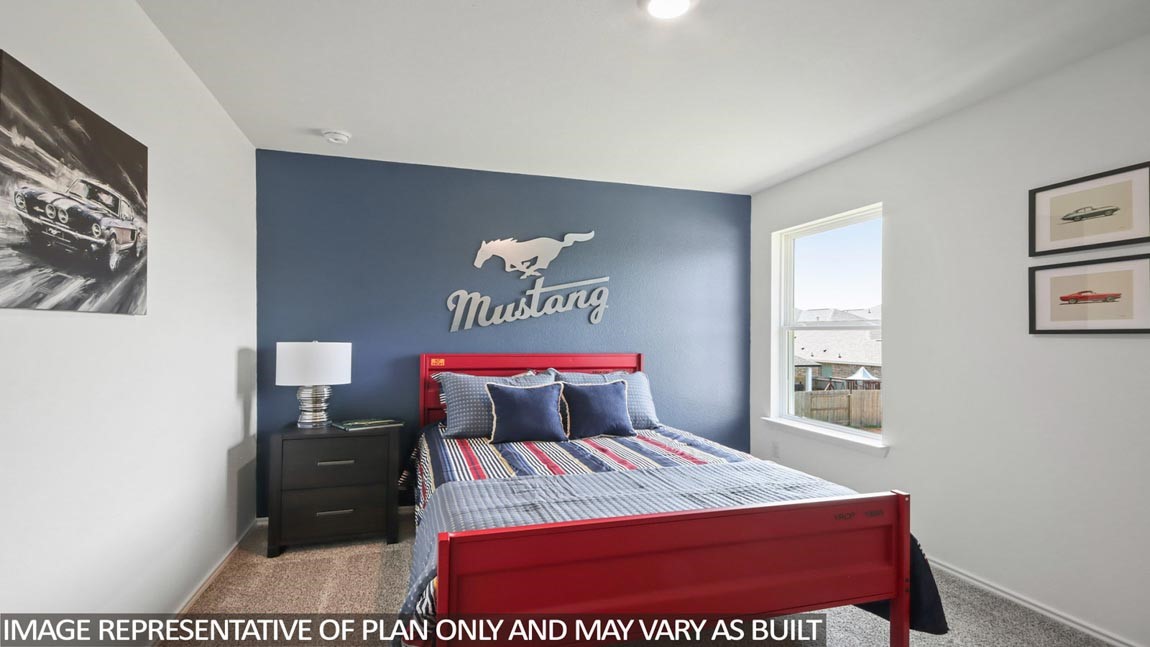 1711 Portia Lane Conroe, TX 77301 - Photo 15 of 26 a bedroom with a bed and a table in it