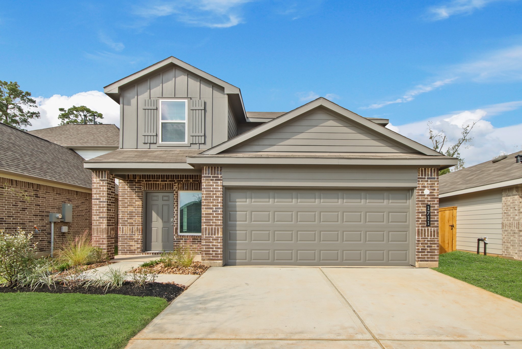 1711 Portia Lane Conroe, TX 77301 - Photo 3 of 26 a front view of a house with a yard