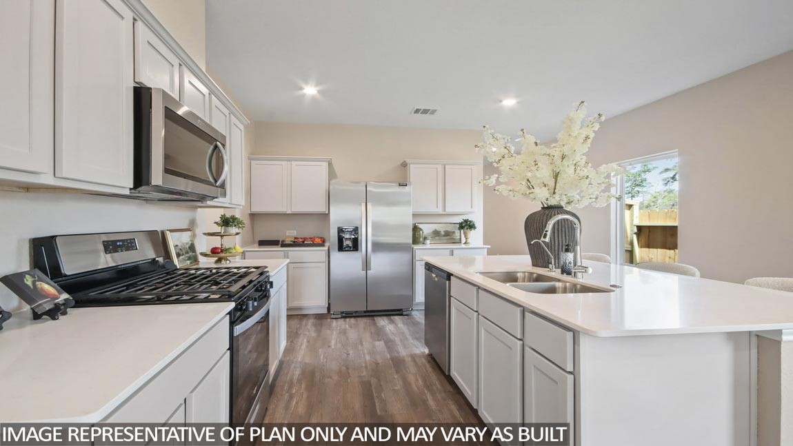 1711 Portia Lane Conroe, TX 77301 - Photo 6 of 26 a kitchen that has a lot of cabinets in it and appliances