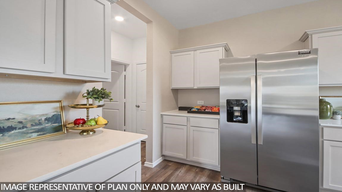 1711 Portia Lane Conroe, TX 77301 - Photo 7 of 26 a kitchen with kitchen island a counter top space cabinets and stainless steel appliances