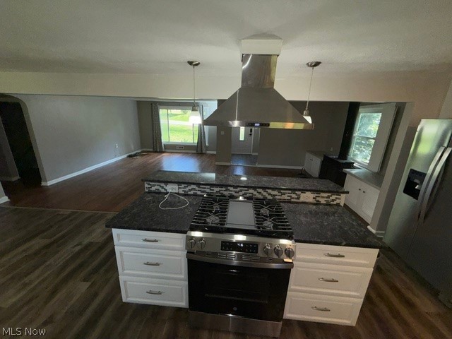 1087 Krumroy Road Akron, OH 44306 - Photo 19 of 38 Kitchen island with built-in gas range, stainless steel range hood, dark granite countertops, and mosaic tile backsplash