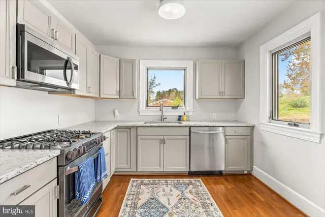 a view of a dining room with furniture and a window