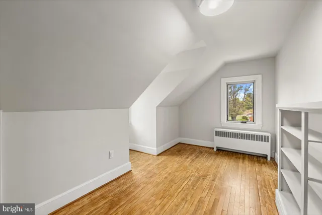 a view of an empty room and wooden floor