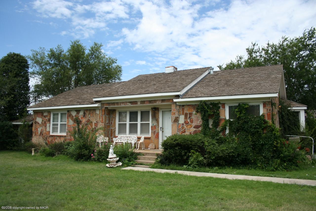 4104 Bowie Street Amarillo, TX 79110 - Photo 1 of 18 a view of a house with brick walls and a yard with plants
