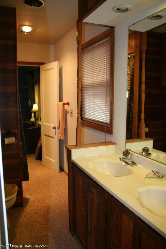 4104 Bowie Street Amarillo, TX 79110 - Photo 11 of 18 a bathroom with a sink and a mirror