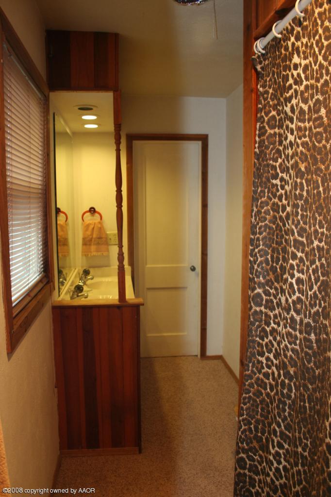4104 Bowie Street Amarillo, TX 79110 - Photo 12 of 18 view of a bathroom with a glass door shower and a sink