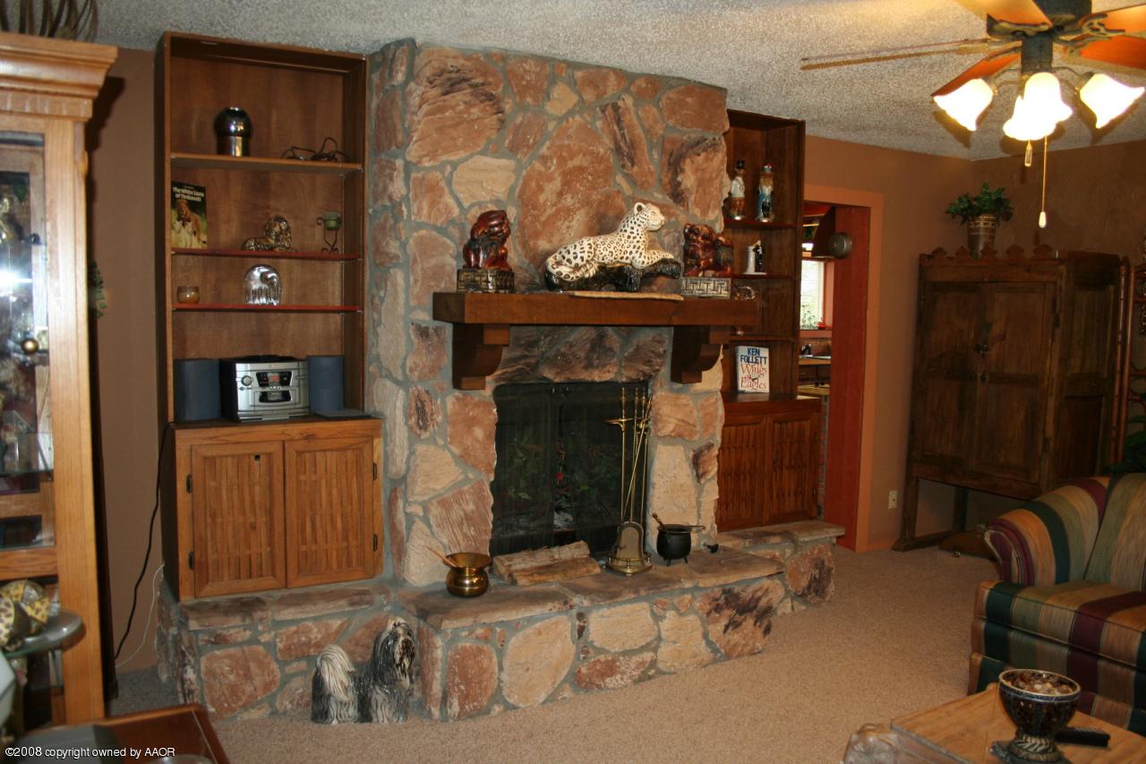 4104 Bowie Street Amarillo, TX 79110 - Photo 2 of 18 a living room with furniture and a fireplace