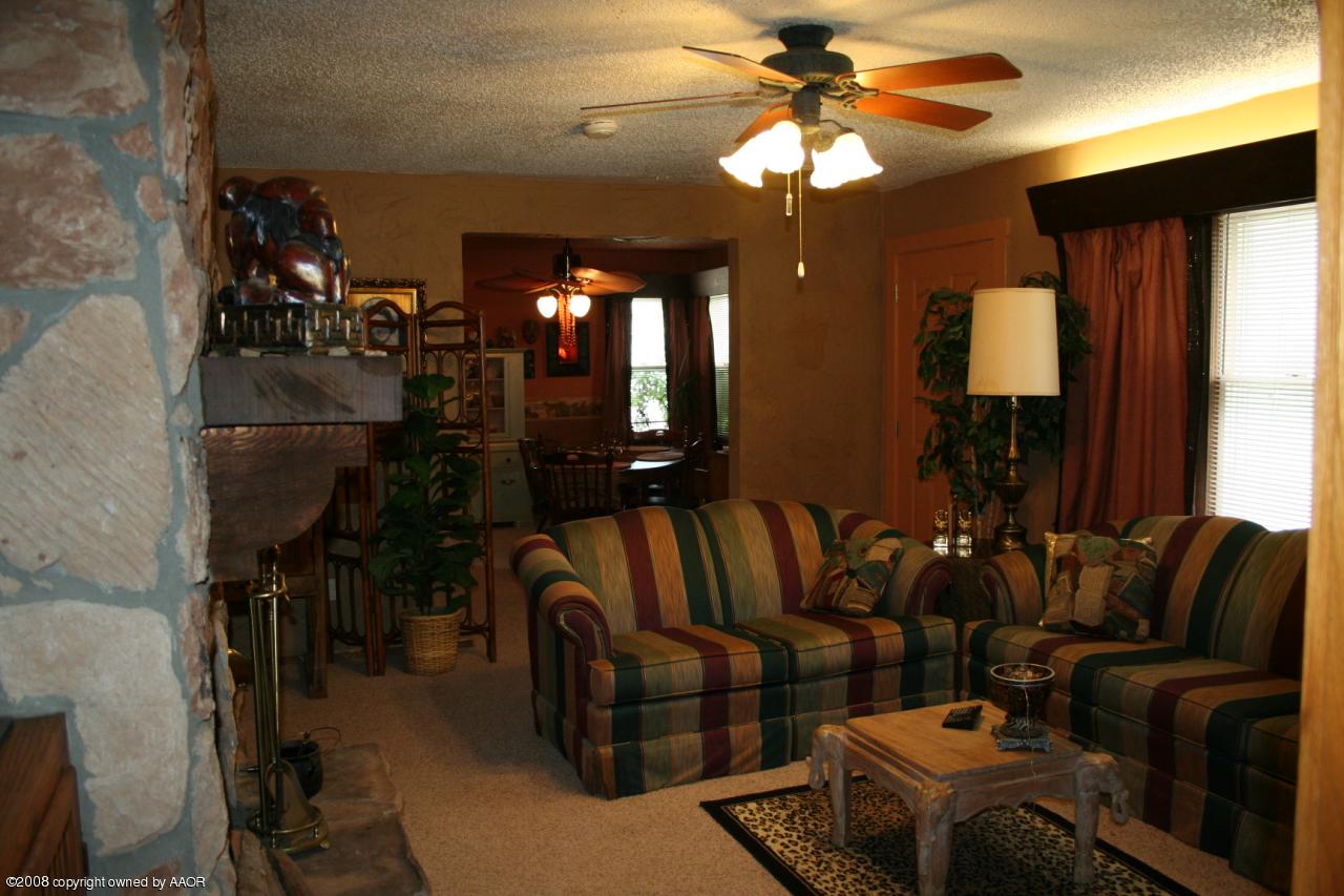 4104 Bowie Street Amarillo, TX 79110 - Photo 3 of 18 a living room with furniture a lamp and a chandelier
