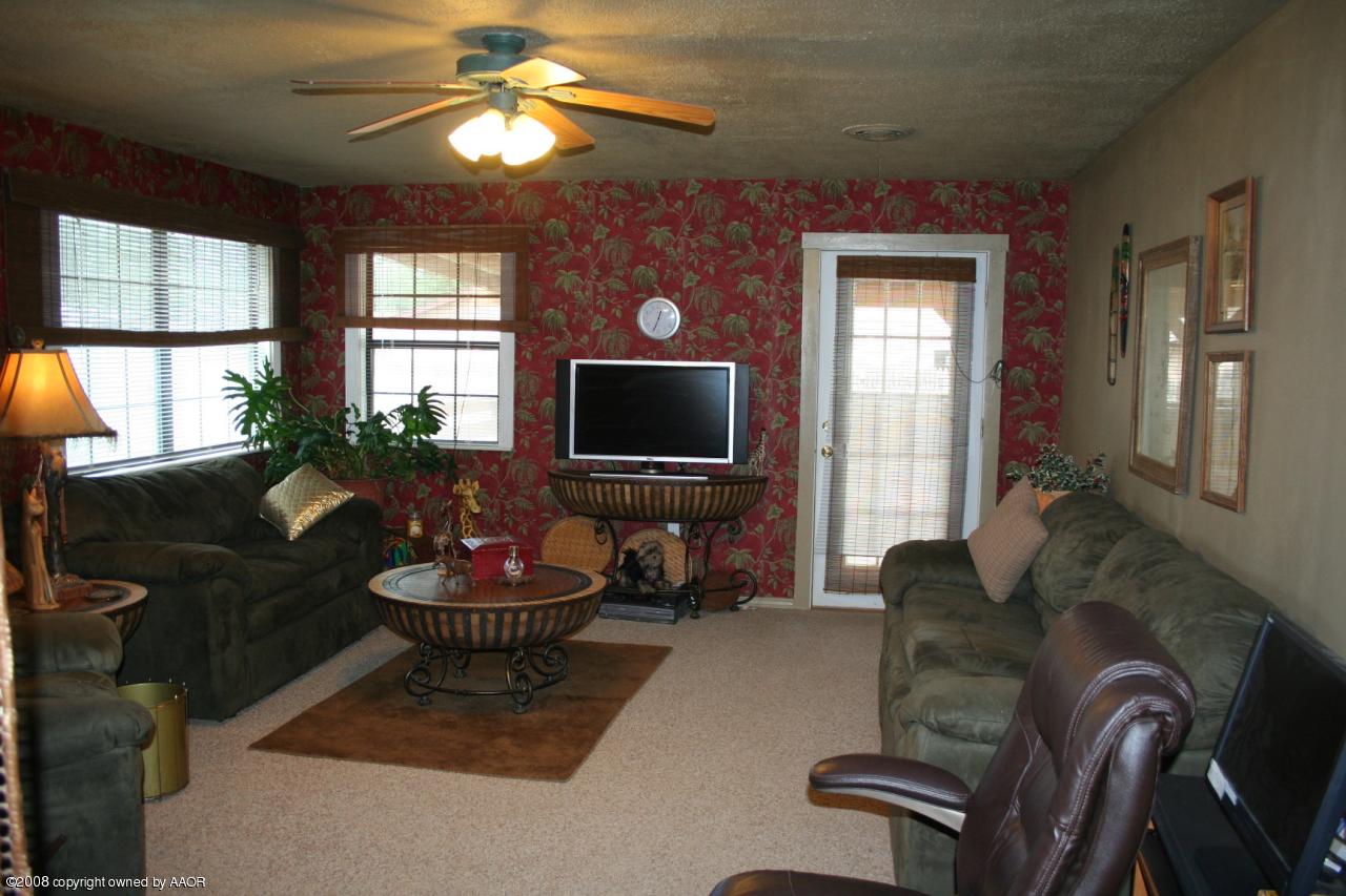 4104 Bowie Street Amarillo, TX 79110 - Photo 4 of 18 a living room with furniture a window and a flat screen tv