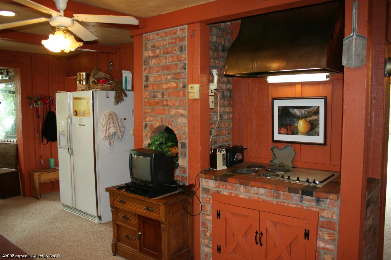 4104 Bowie Street Amarillo, TX 79110 - Photo 7 of 18 a kitchen with stainless steel appliances granite countertop a stove and a refrigerator