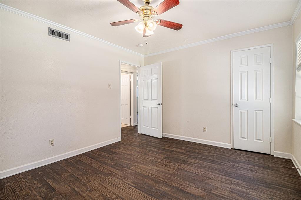 1814 Addington Drive Carrollton, TX 75007 - Photo 20 of 24 Unfurnished room featuring dark hardwood / wood-style flooring, ceiling fan, and ornamental molding