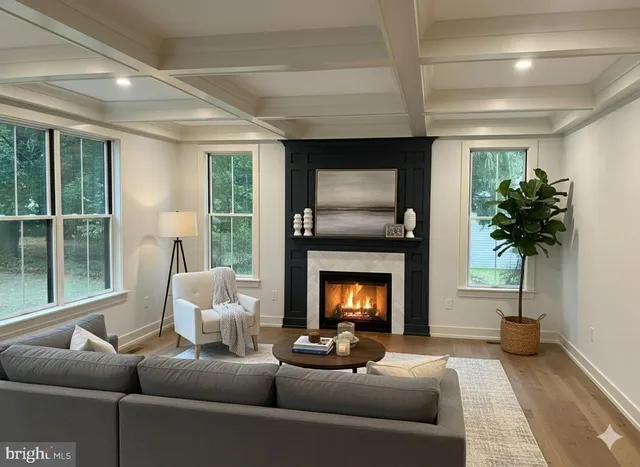 a dining room with furniture wooden floor and a chandelier