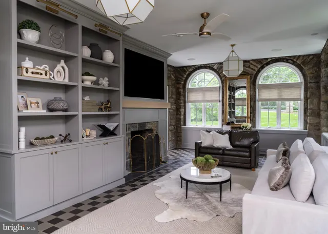 a living room with furniture a fireplace and a flat screen tv