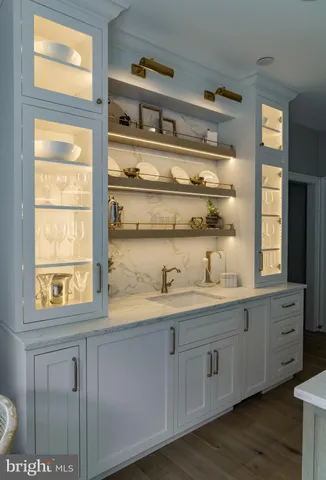 a view of kitchen with wooden floor and cabinets