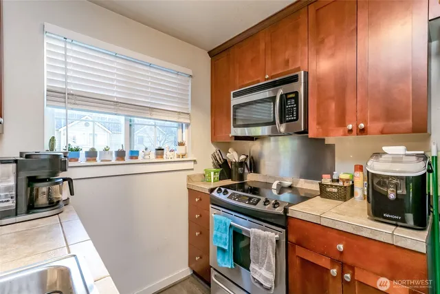 a kitchen with a stove and a refrigerator