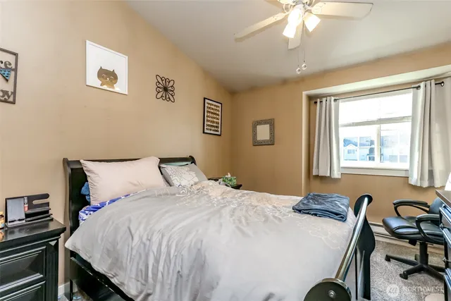 a bedroom with furniture and a flat screen tv