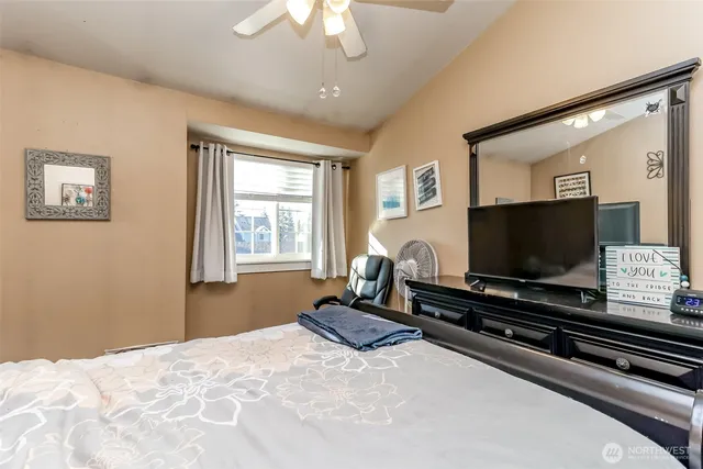 a bedroom with bed and wooden floor