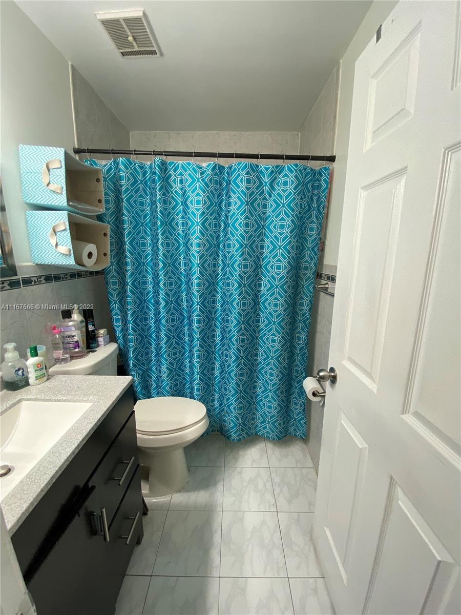 2879 West 75th Terrace Hialeah, FL 33018 - Photo 12 of 16 a bathroom with a sink a toilet and a tub