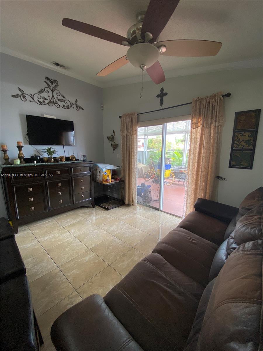 2879 West 75th Terrace Hialeah, FL 33018 - Photo 6 of 16 a living room with furniture and a flat screen tv