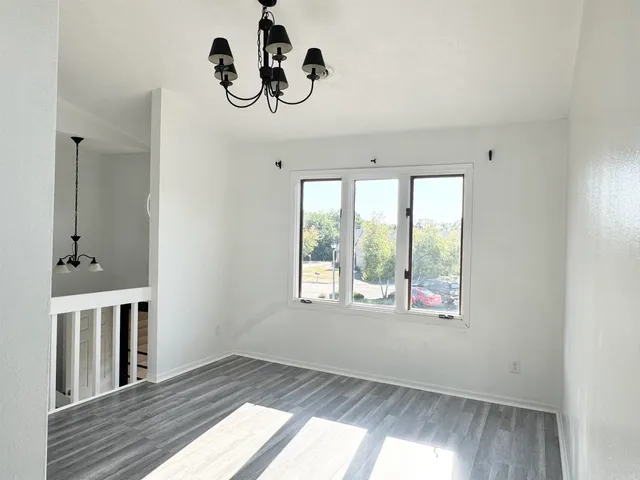 a view of a room with window and ceiling fan