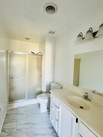 a bathroom with a sink toilet and shower