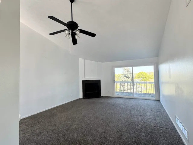 a kitchen with stainless steel appliances a white cabinets and wooden floor