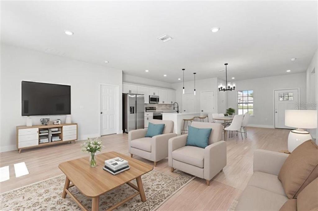 3875 Southwest 169th Ln Road Ocala, FL 34473 - Photo 12 of 46 a living room with furniture and a flat screen tv