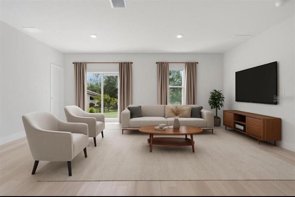 3875 Southwest 169th Ln Road Ocala, FL 34473 - Photo 13 of 46 a living room with furniture and a flat screen tv