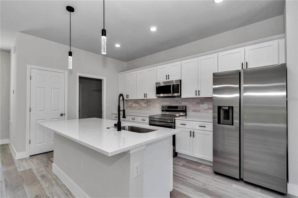 3875 Southwest 169th Ln Road Ocala, FL 34473 - Photo 15 of 46 a kitchen with stainless steel appliances a refrigerator sink and microwave