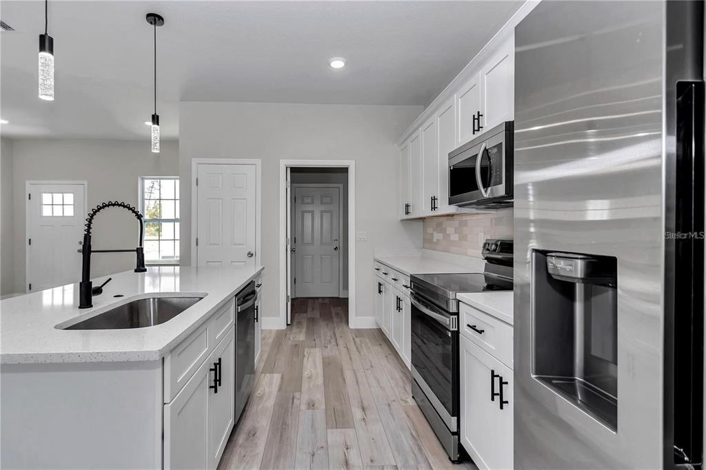 3875 Southwest 169th Ln Road Ocala, FL 34473 - Photo 16 of 46 a kitchen with kitchen island granite countertop a sink stainless steel appliances and cabinets