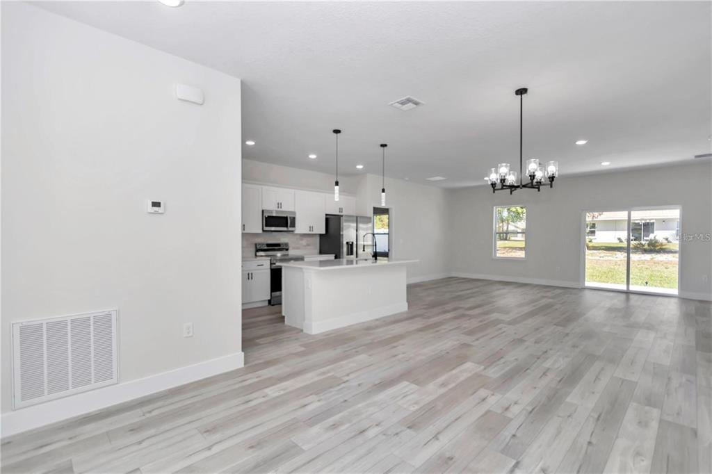 3875 Southwest 169th Ln Road Ocala, FL 34473 - Photo 23 of 46 a view of an empty room with kitchen and window