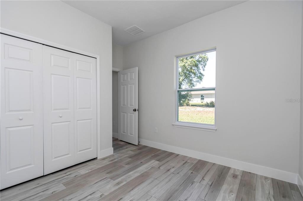 3875 Southwest 169th Ln Road Ocala, FL 34473 - Photo 32 of 46 an empty room with wooden floor and window