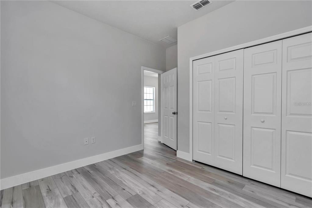 3875 Southwest 169th Ln Road Ocala, FL 34473 - Photo 34 of 46 a view of an empty room with closet and wooden floor